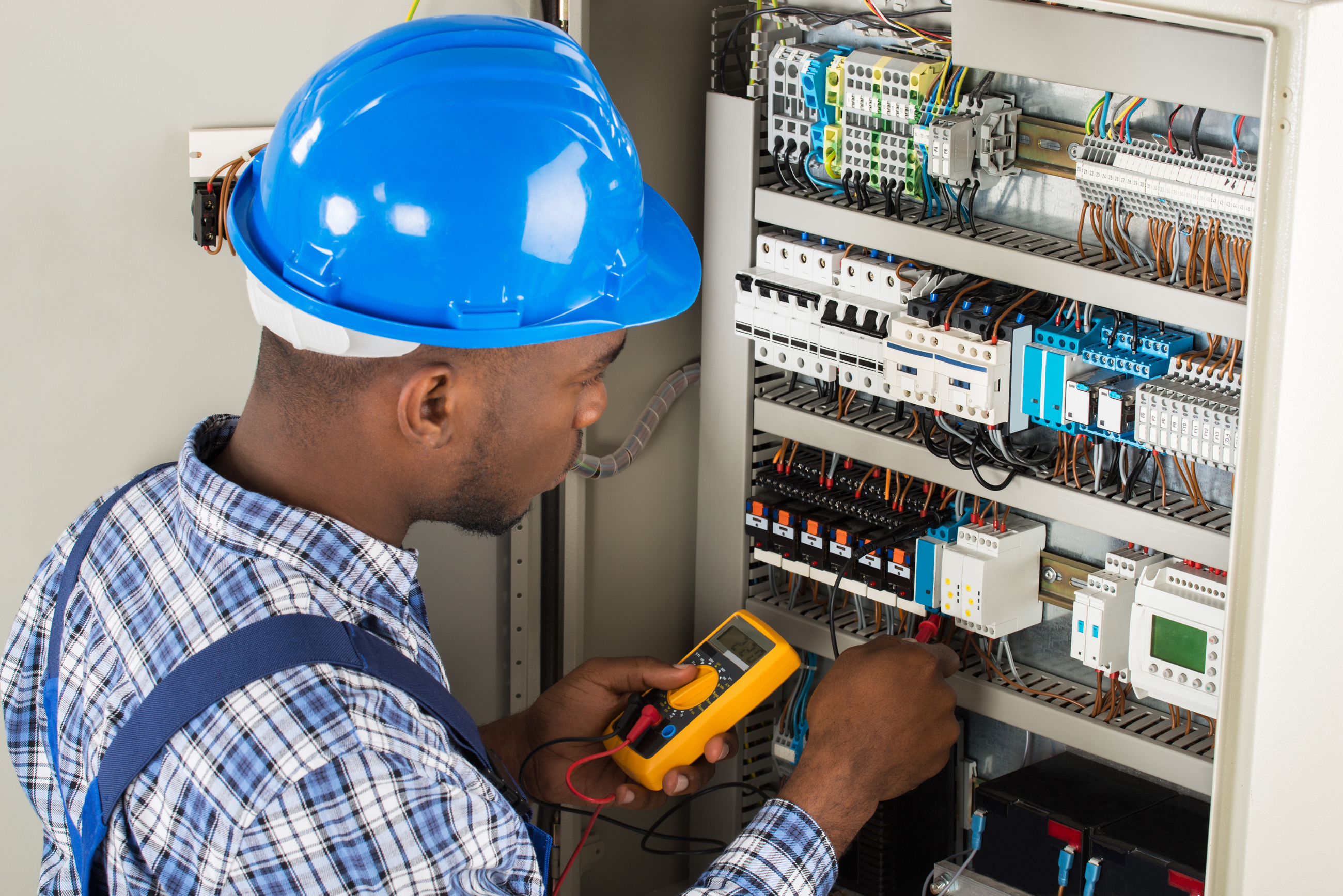 Electrician working on a power panel