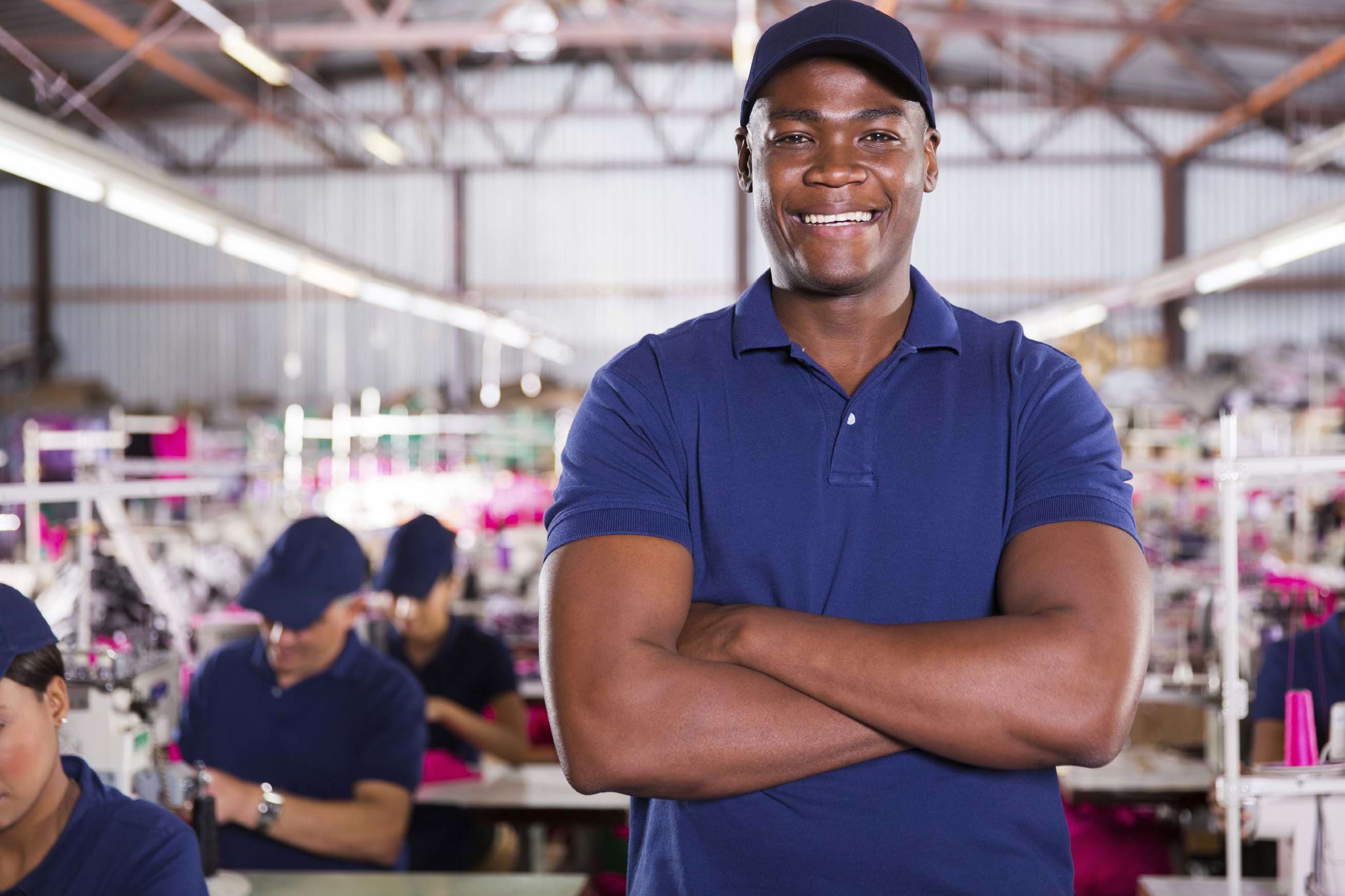 Smiling man in a clothing factory
