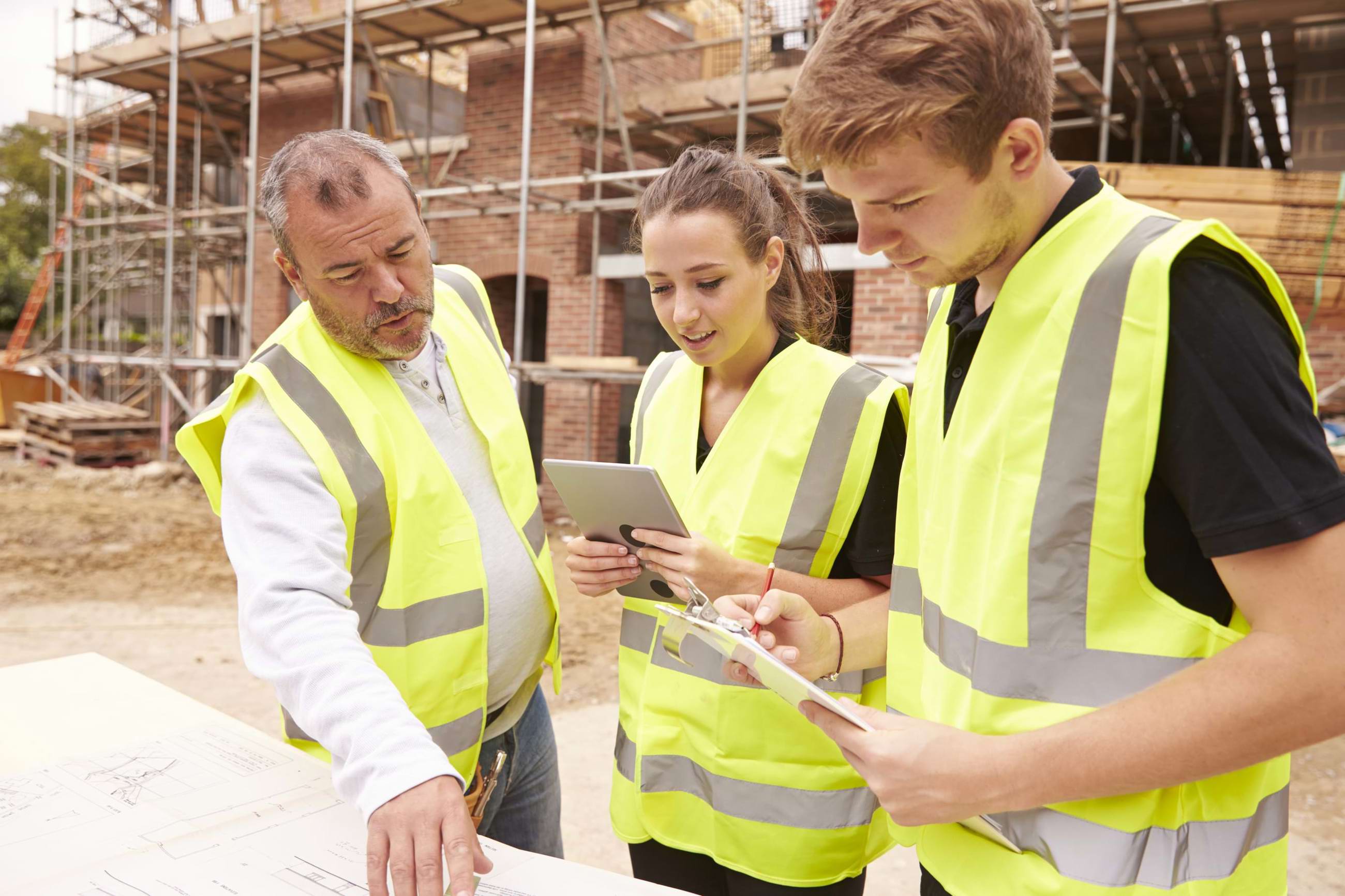 Group of young construction workers in a site