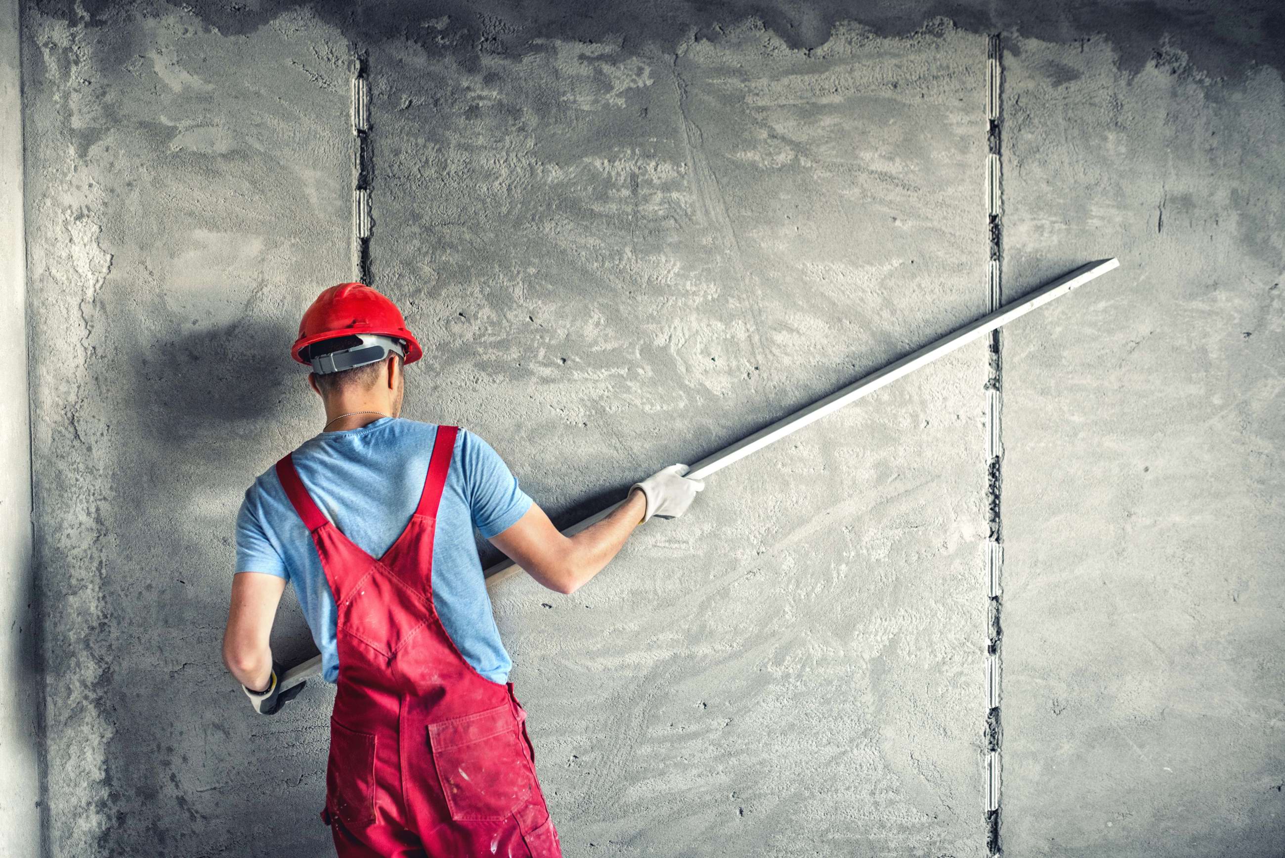 Construction worker installing sheetrock