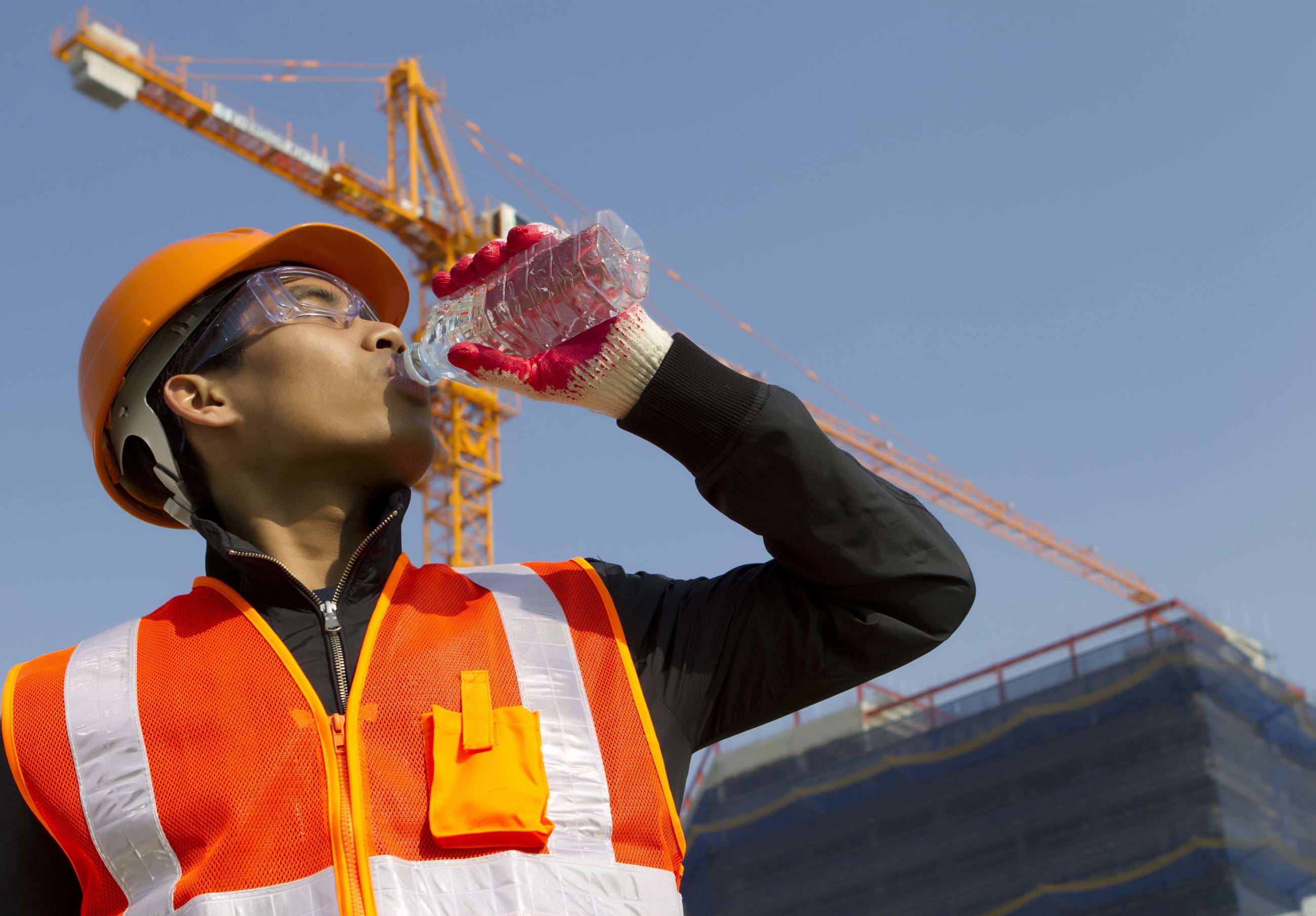 Construction worker drinking water